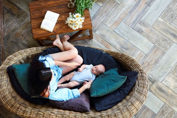 mother-with-baby-resting-on-sofa-2025-01-09-22-04-09-utc